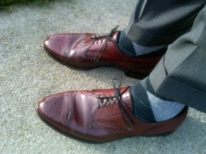 Reddish brown (cordovan) or tan shoes look great with grey / black.